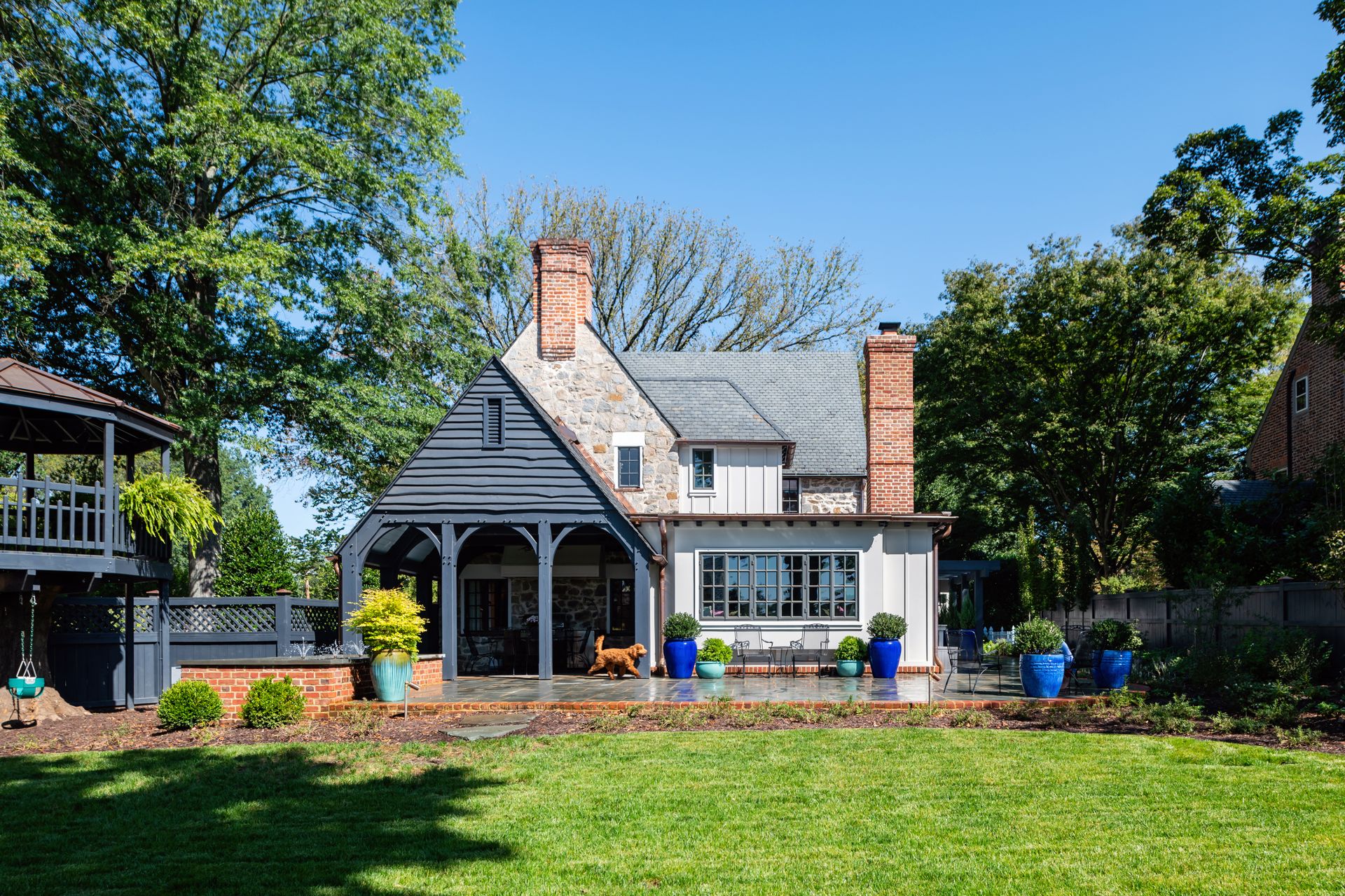 a large stone house with a blue garage door