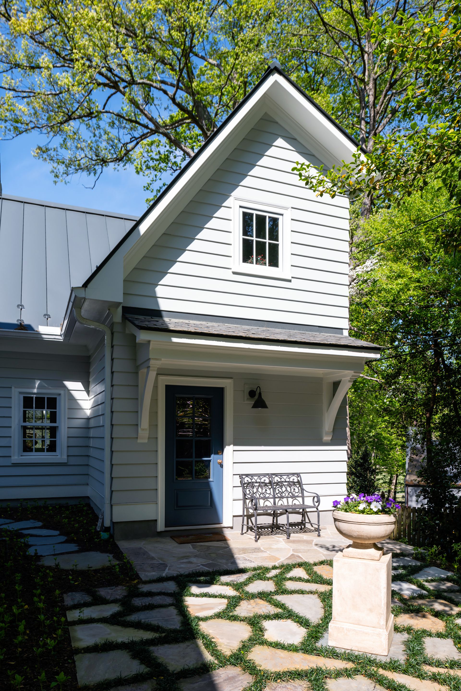 a small white house with a blue door