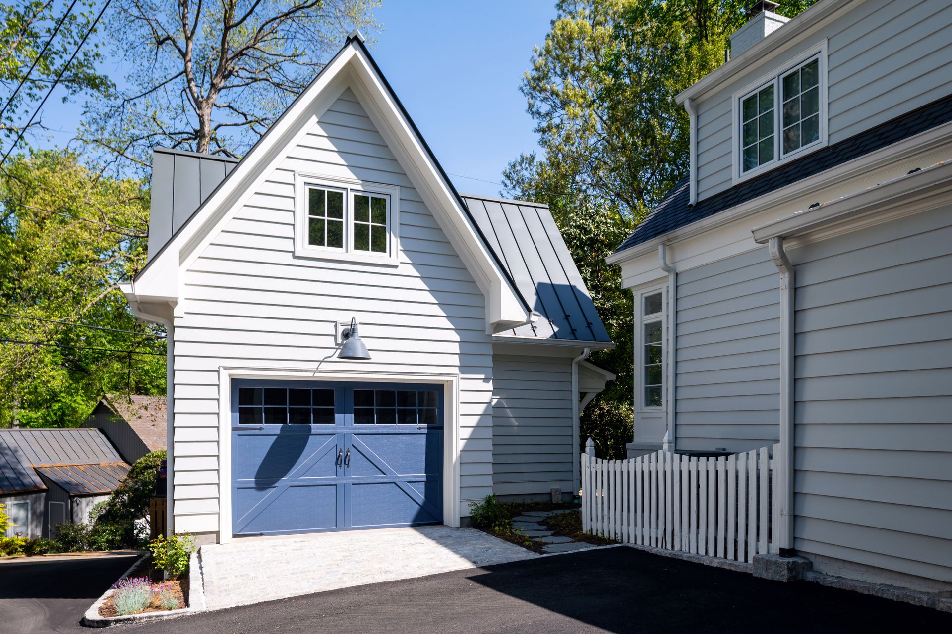 a white house with a blue garage door