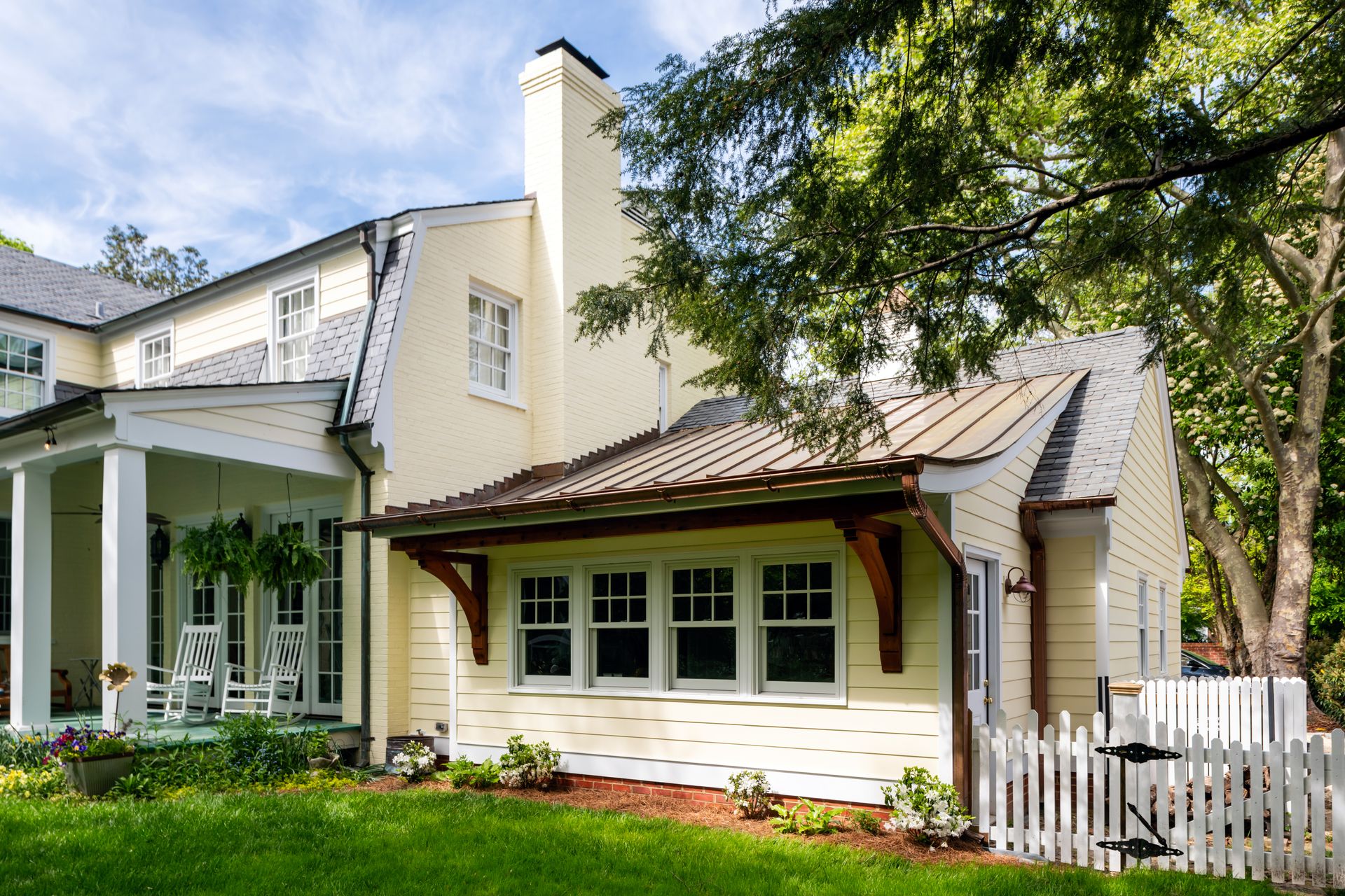 a house with a porch and a white picket fence