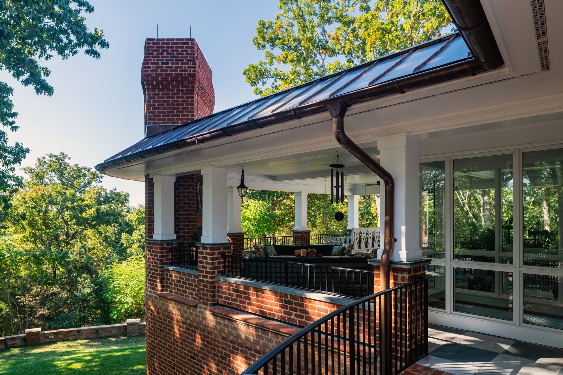 exterior of a second story brick house with an outdoor patio