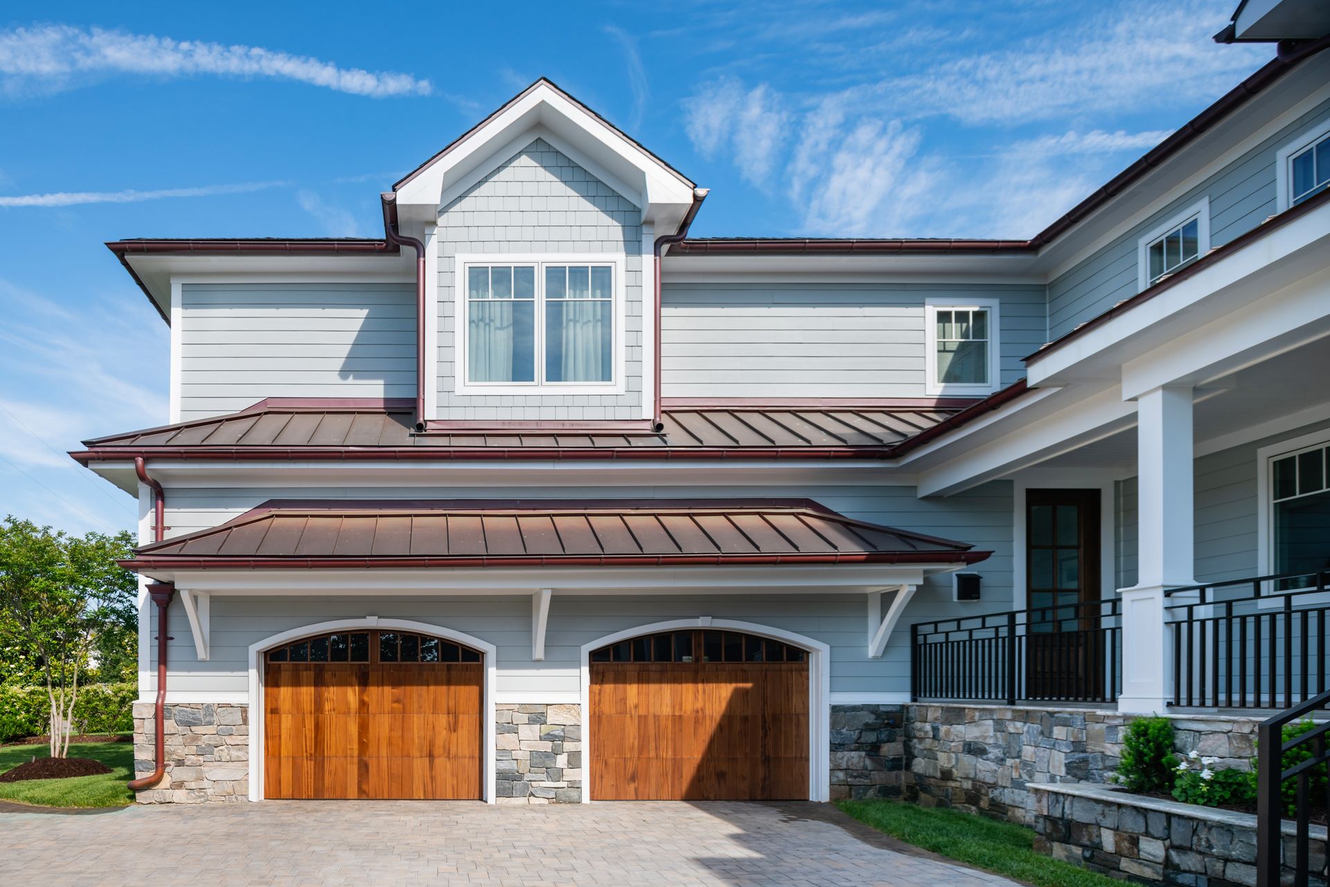 a large house with a wooden garage door
