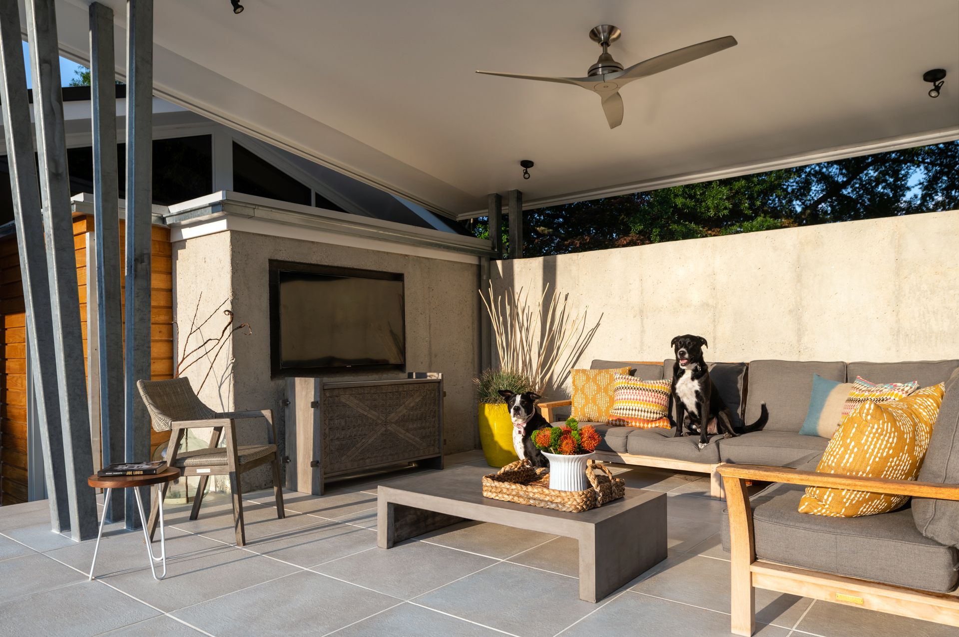 a dog sitting on a couch in an outdoor living room