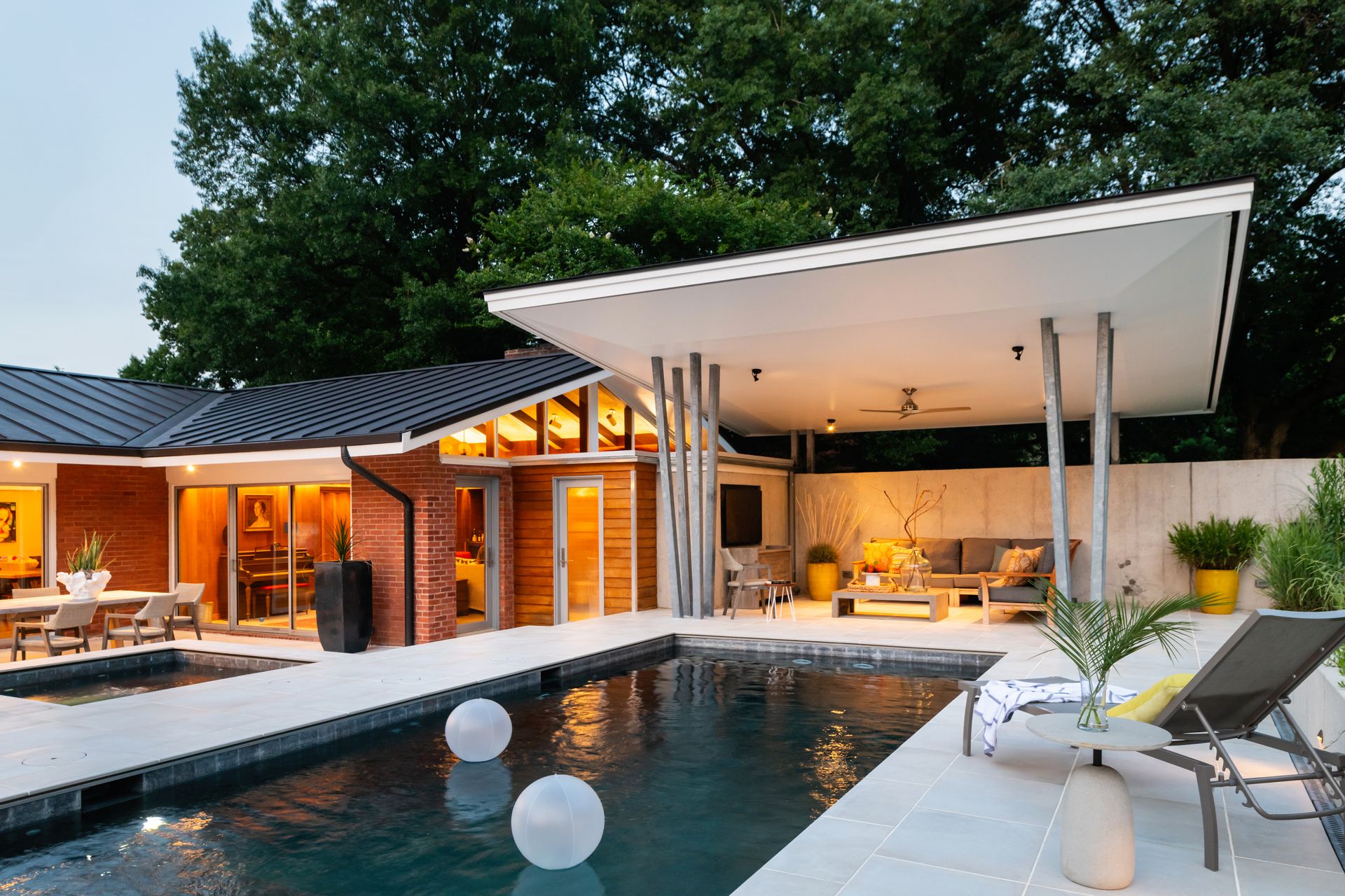 a house with a large swimming pool in front of it