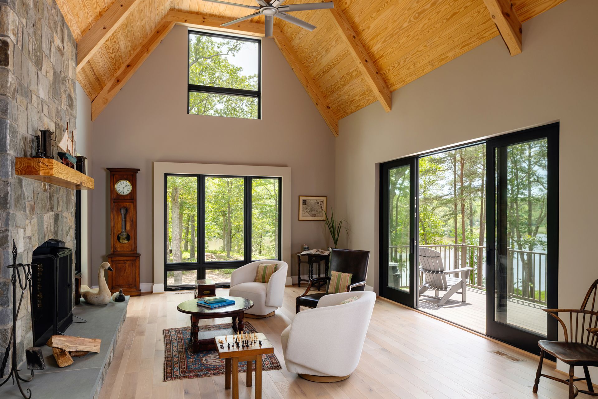 A living room with a vaulted ceiling and lots of windows