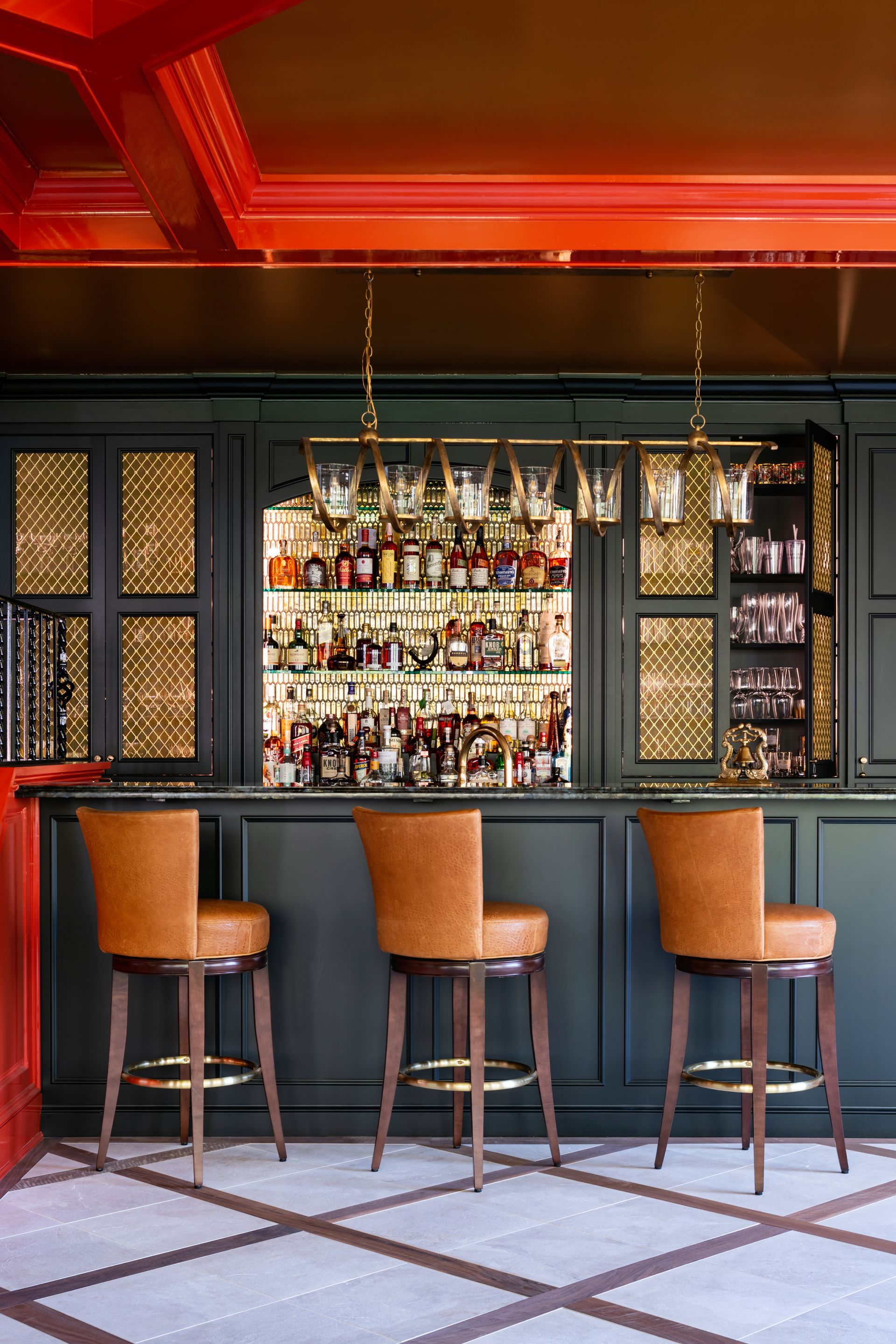a living room with red walls and a blue couch