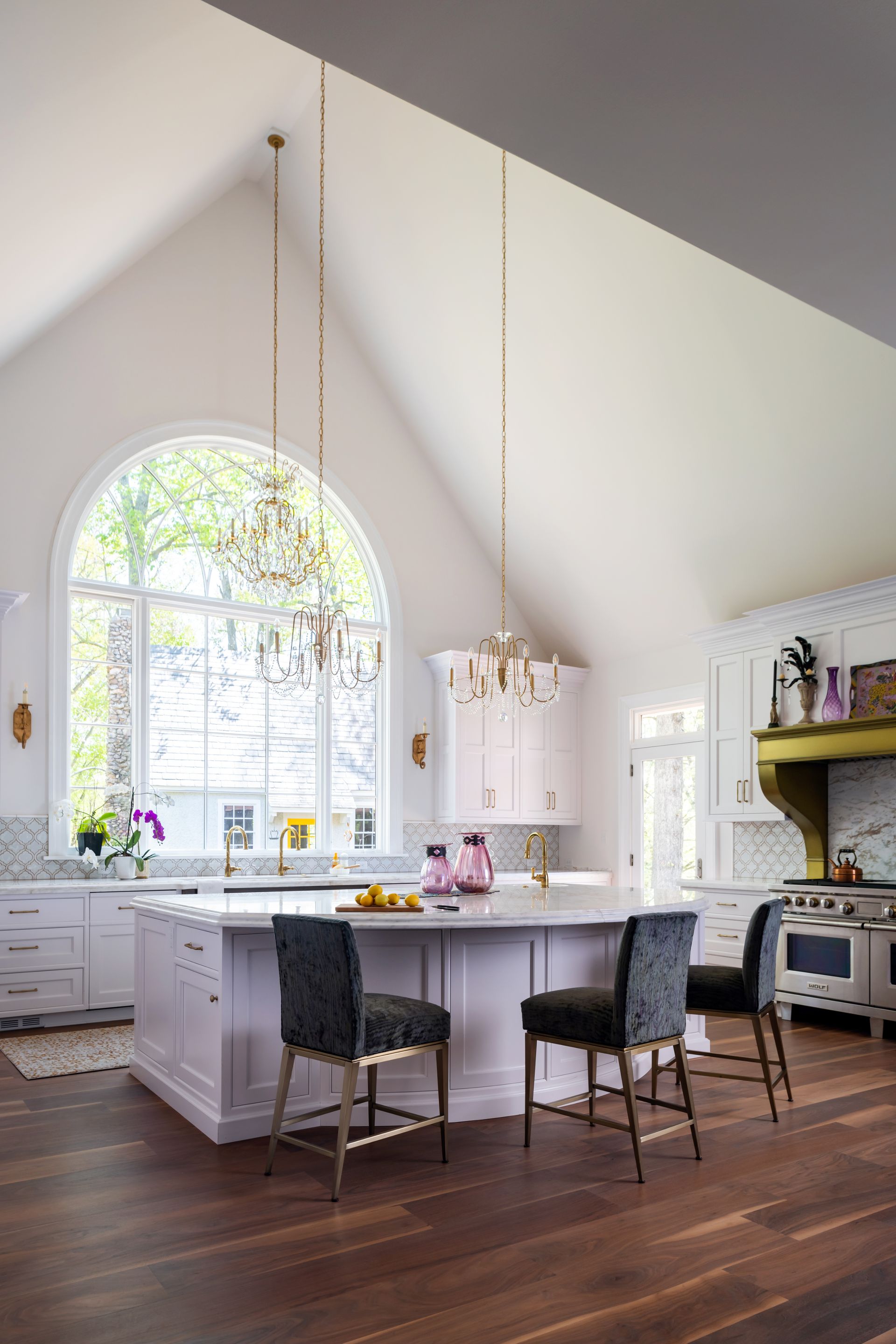 image of a large kitchen with cathedral ceilings and white countertops and white cabinets