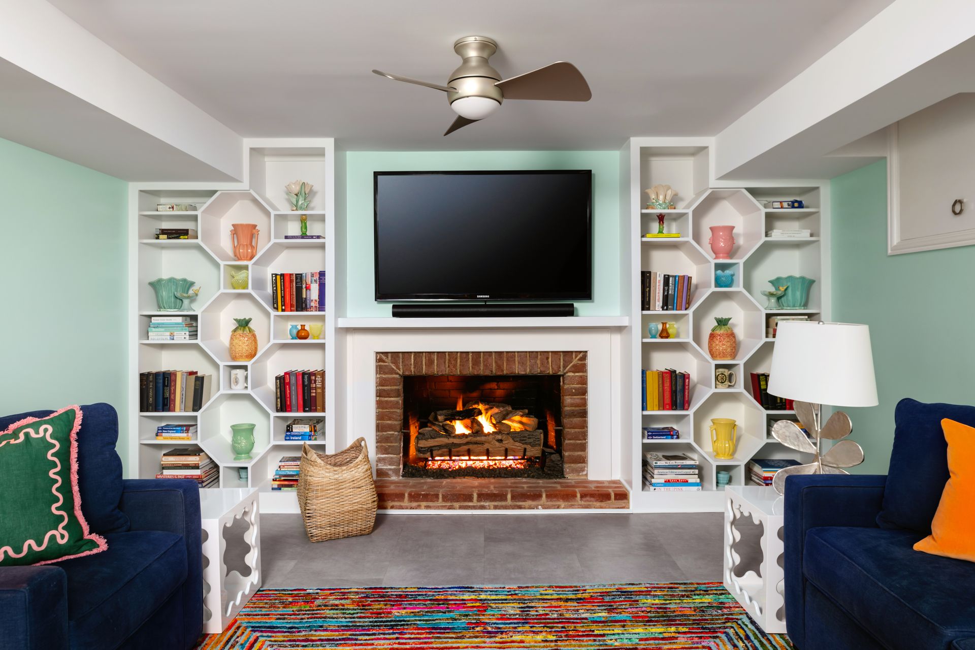 a living room with a fireplace and a flat screen tv