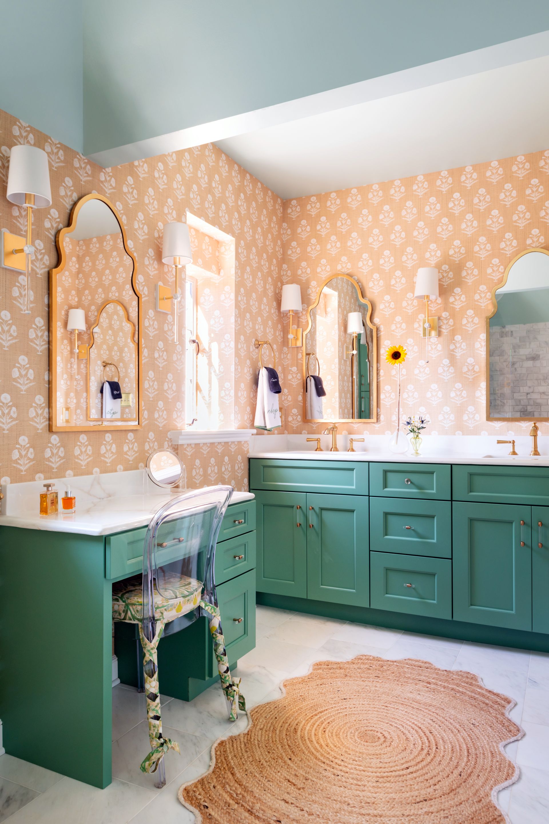 a bathroom with green cabinets and two mirrors