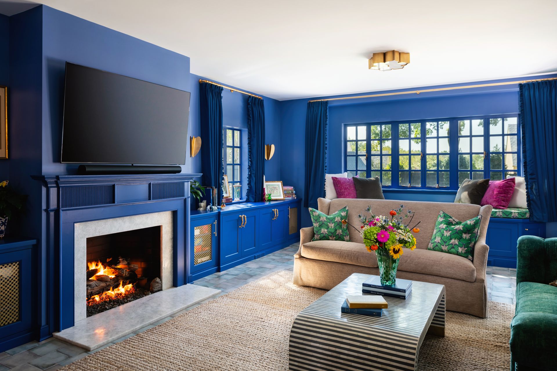 a living room with blue walls and a fireplace