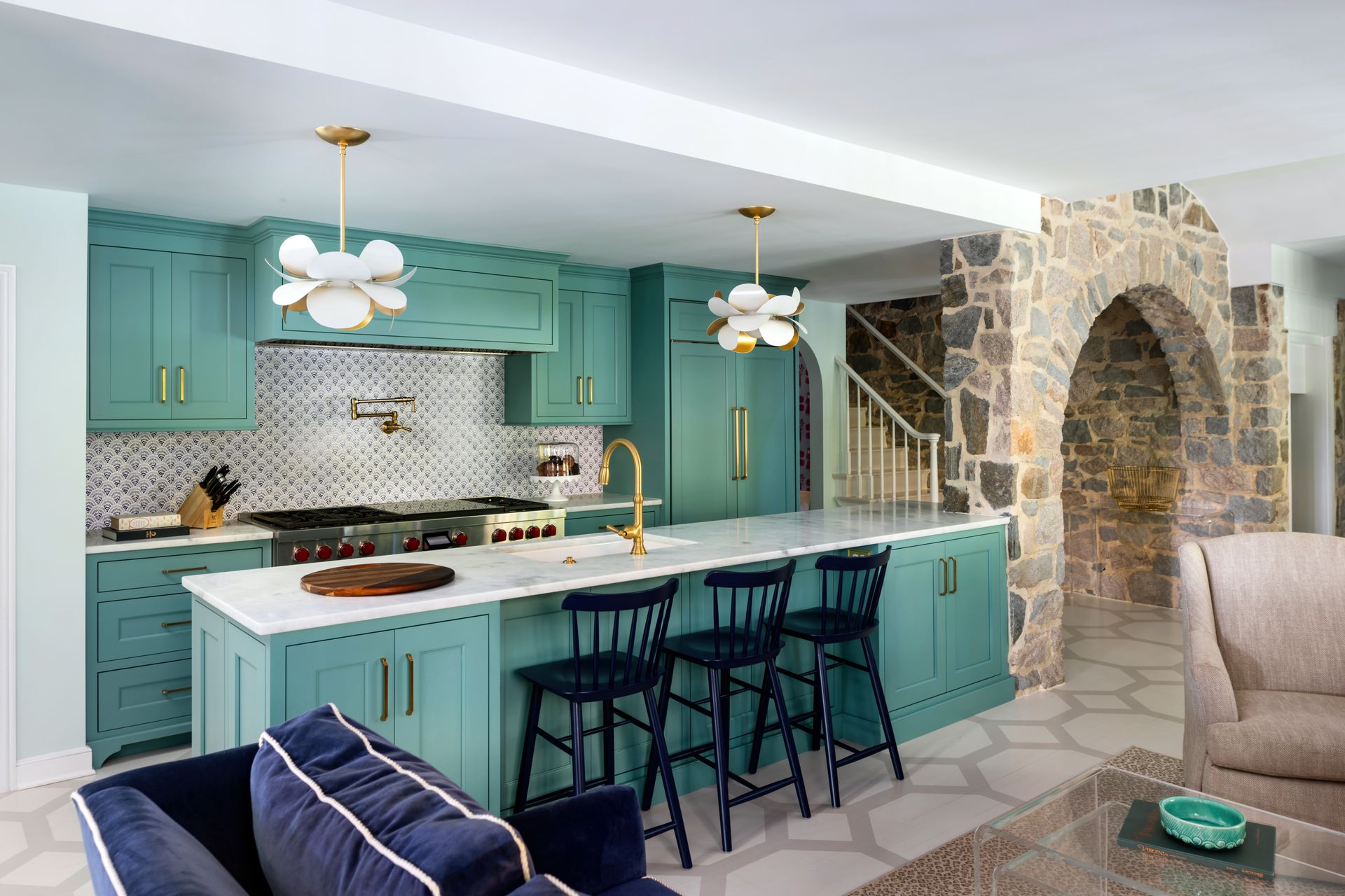 a kitchen with green cabinets and blue stools