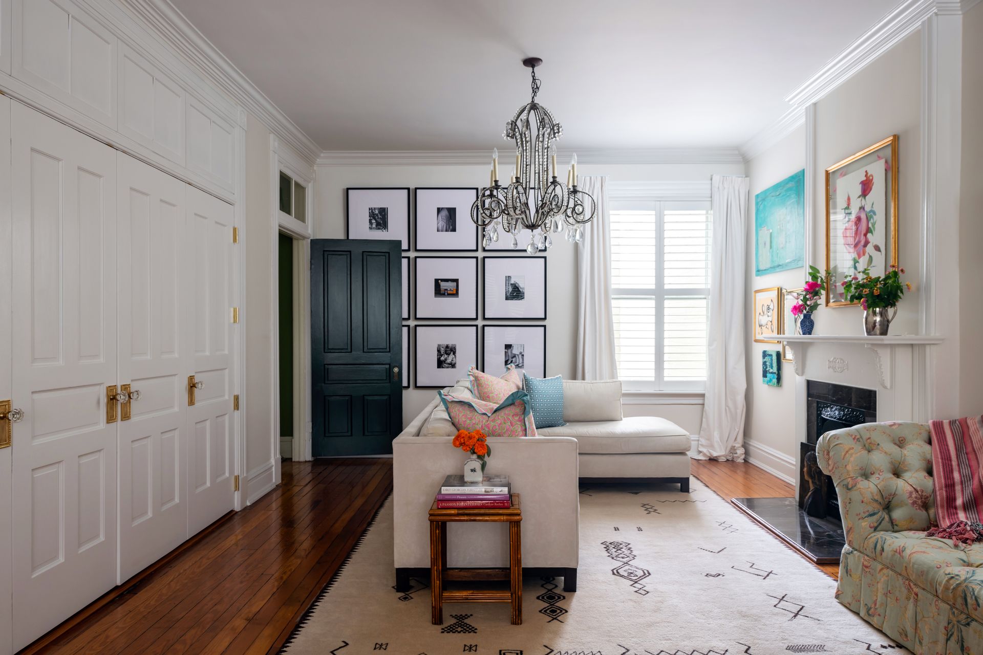 a living room with a white couch and a chandelier