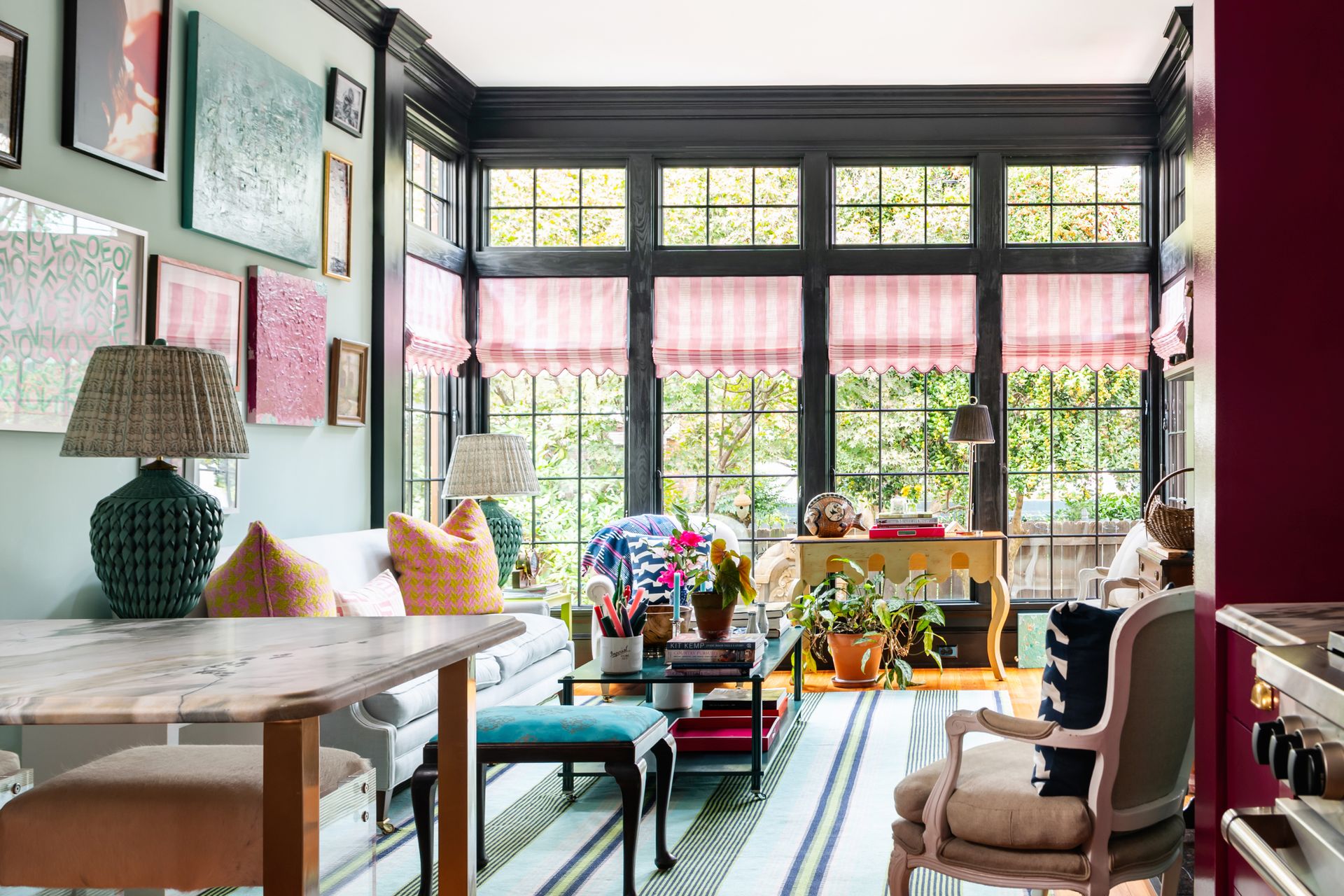 a living room with green walls and a pink coffee table