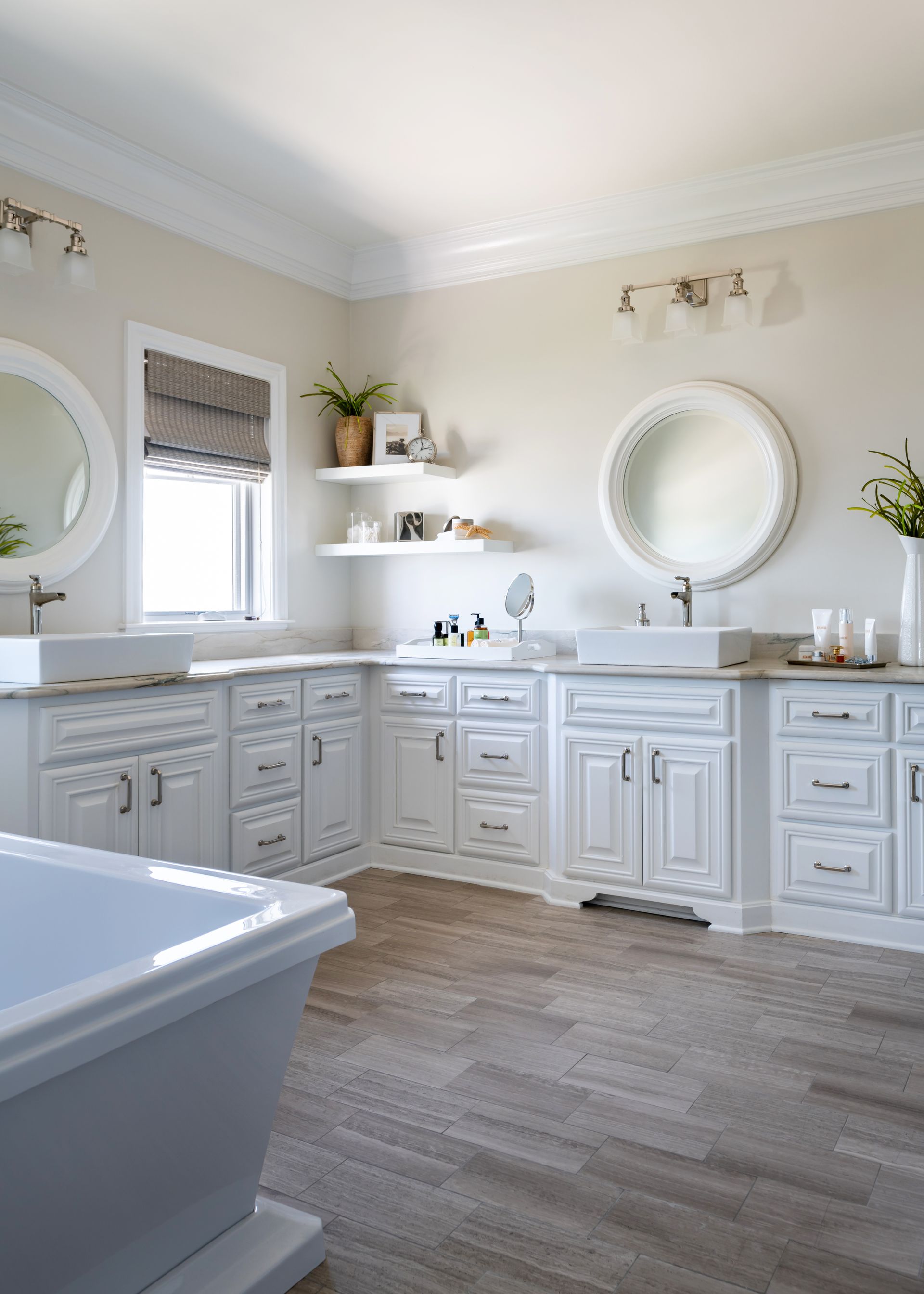 a bathroom with white cabinets and two sinks