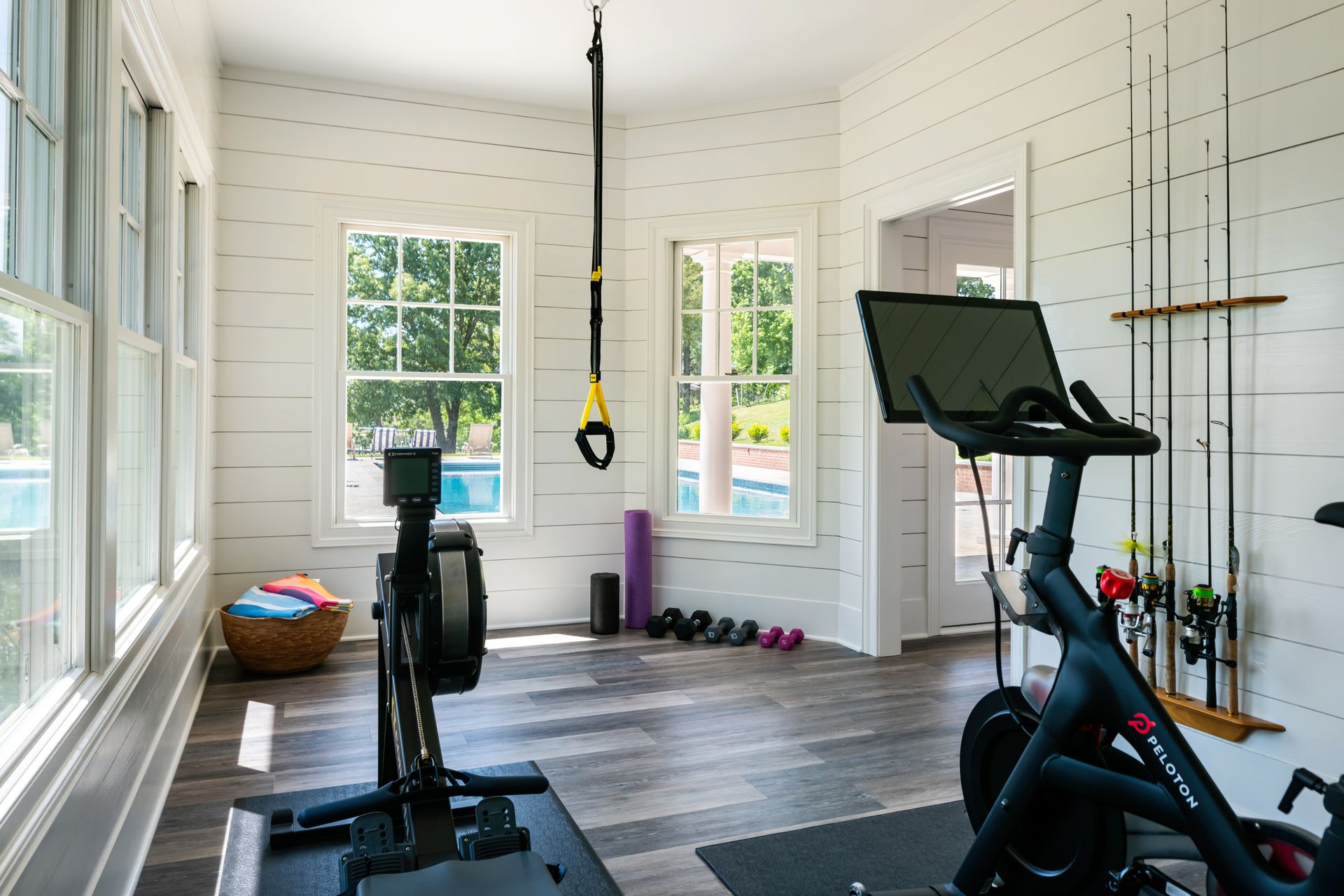 pool house gym with white walls and exercise bike
