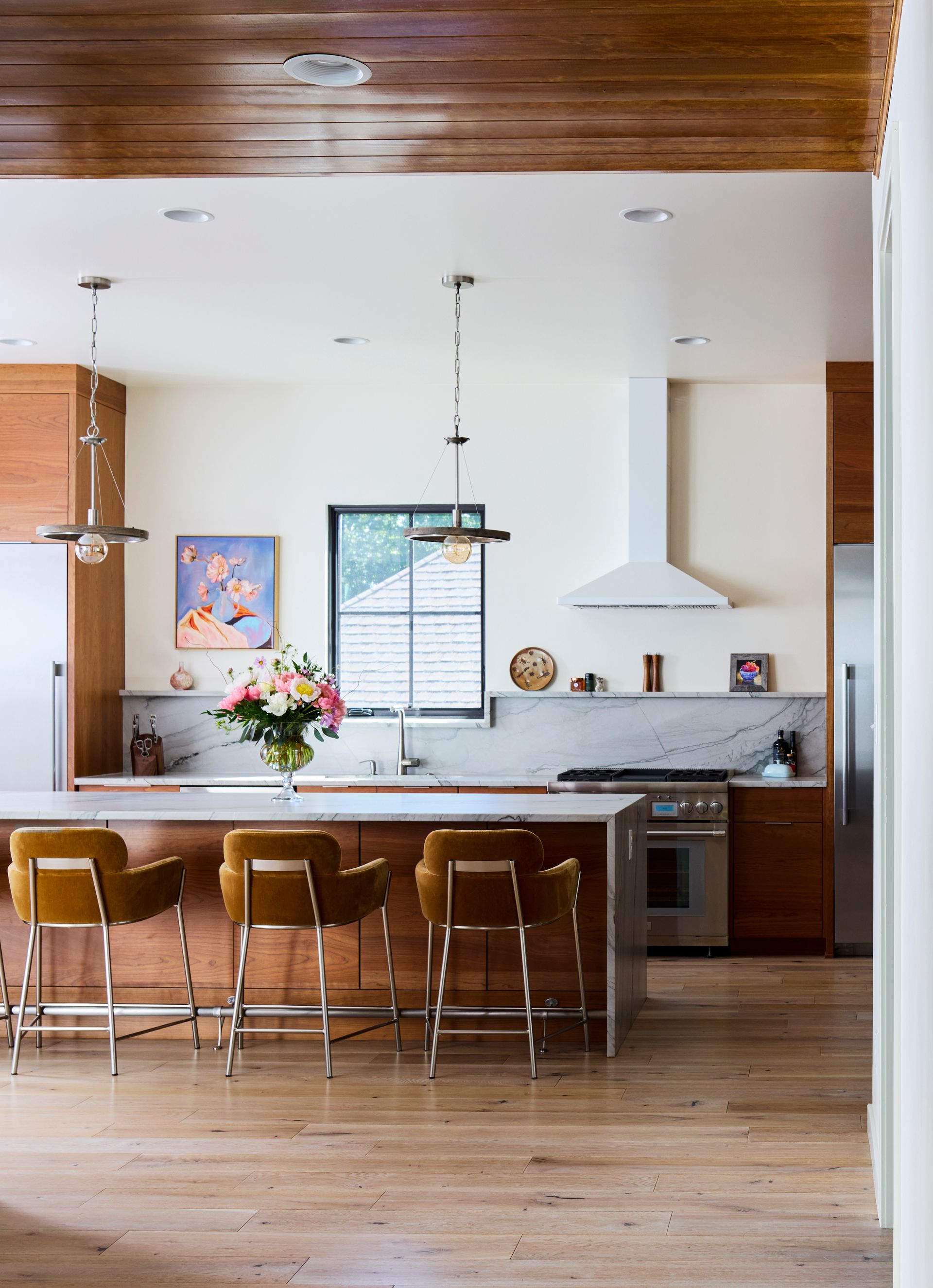 A kitchen with a large island and stools
