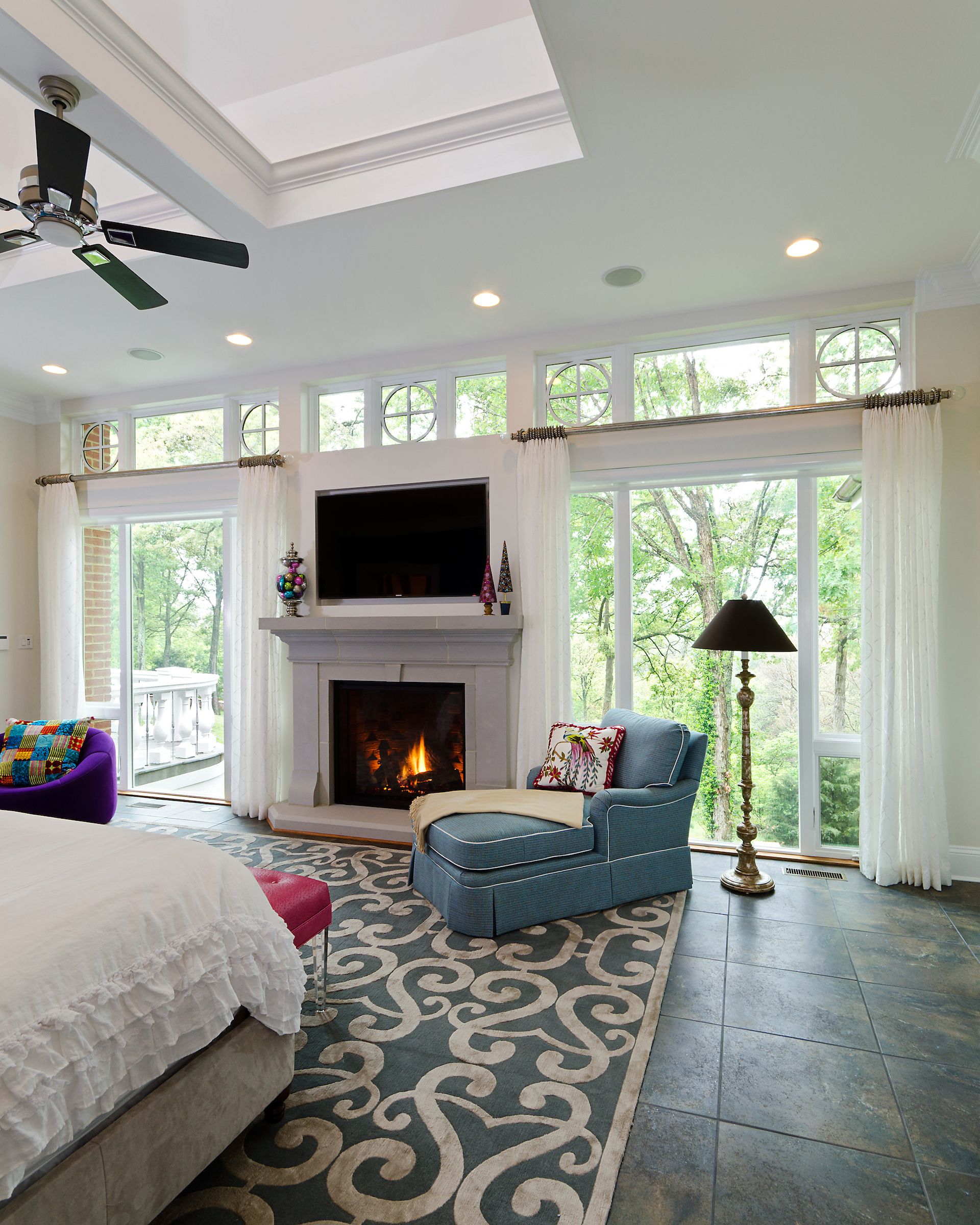 a bedroom with a fireplace and a flat screen tv