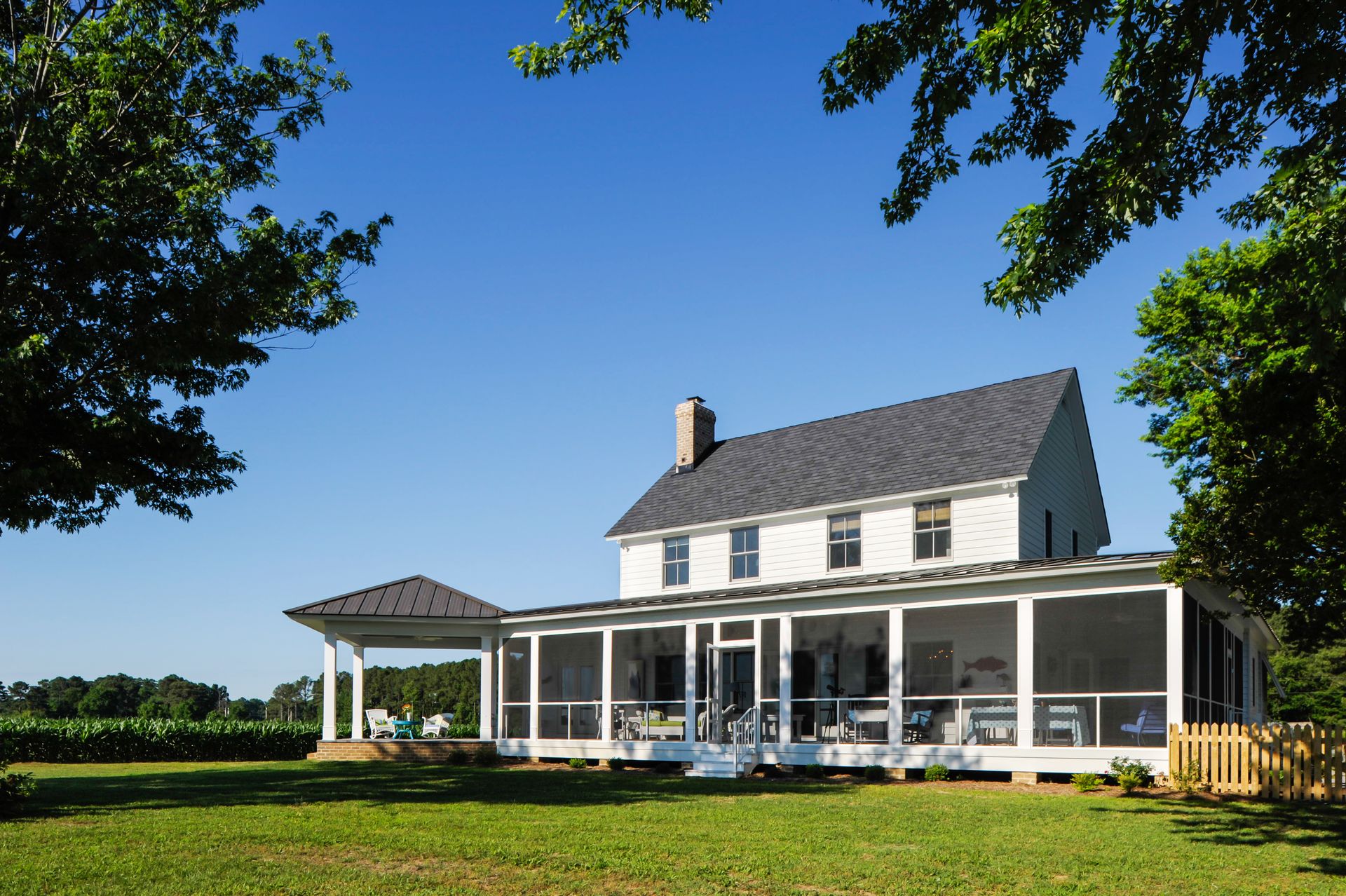 a large white house with a screened in porch