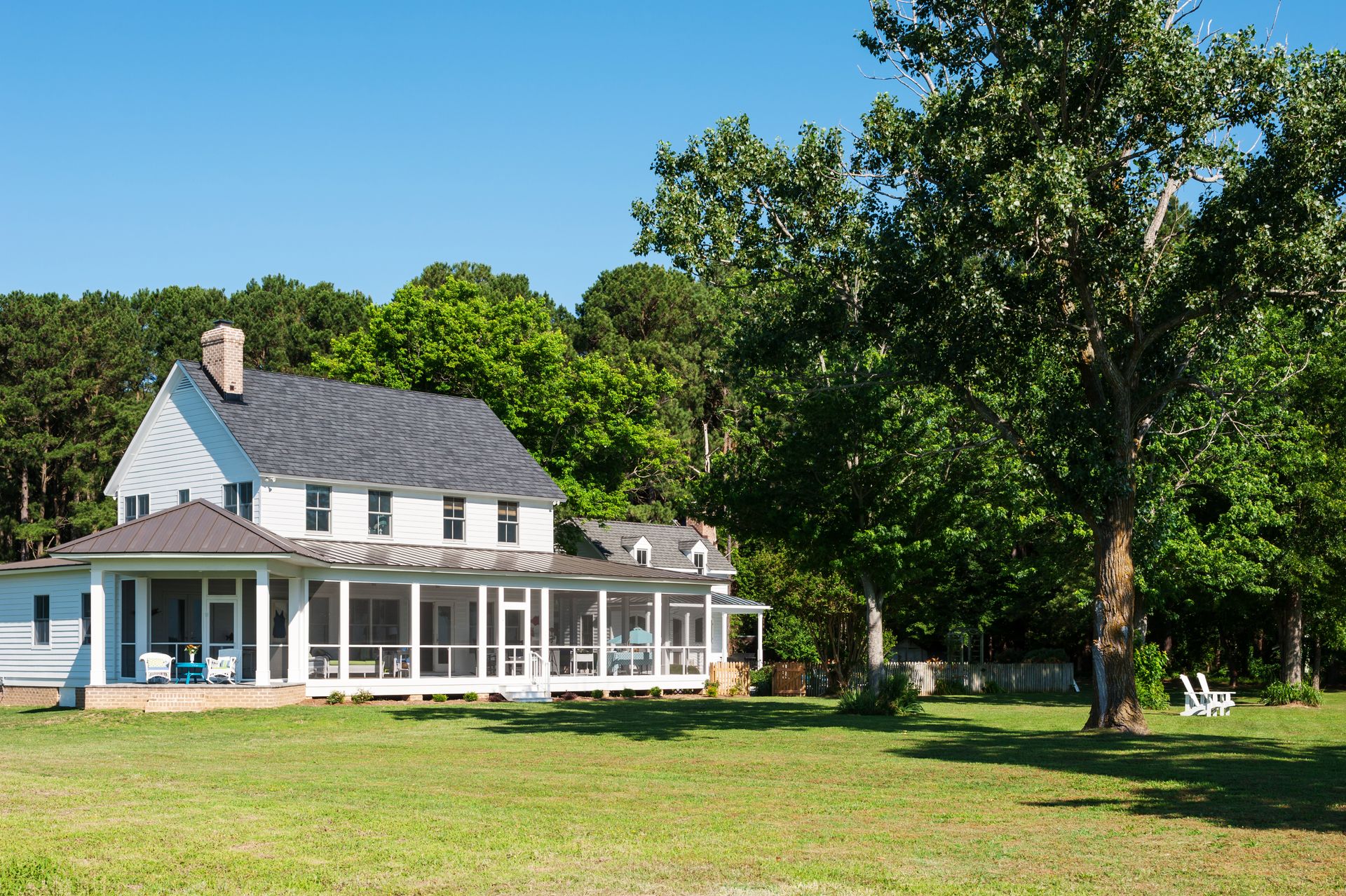 a large white house with a screened in porch