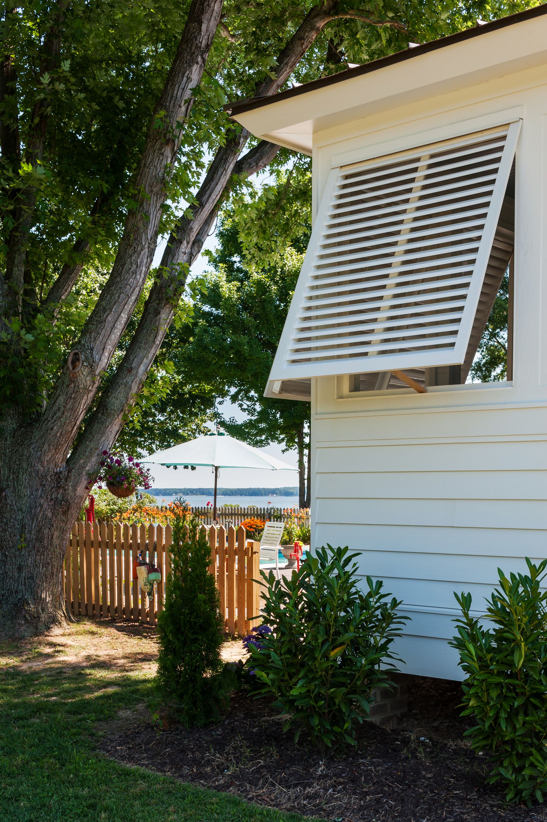 a white house with a wooden fence in front of it