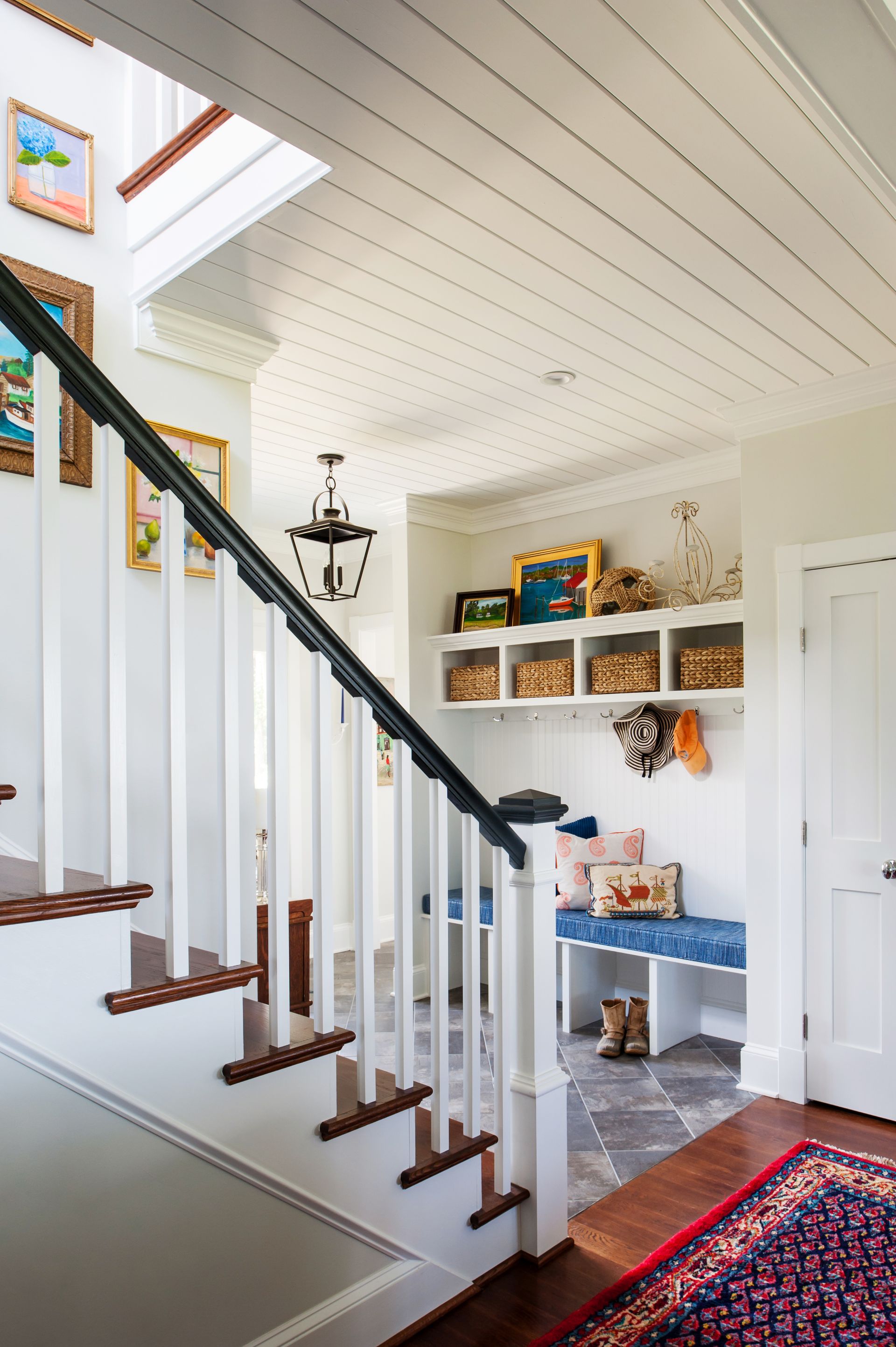 a staircase leading up to a room with a bench