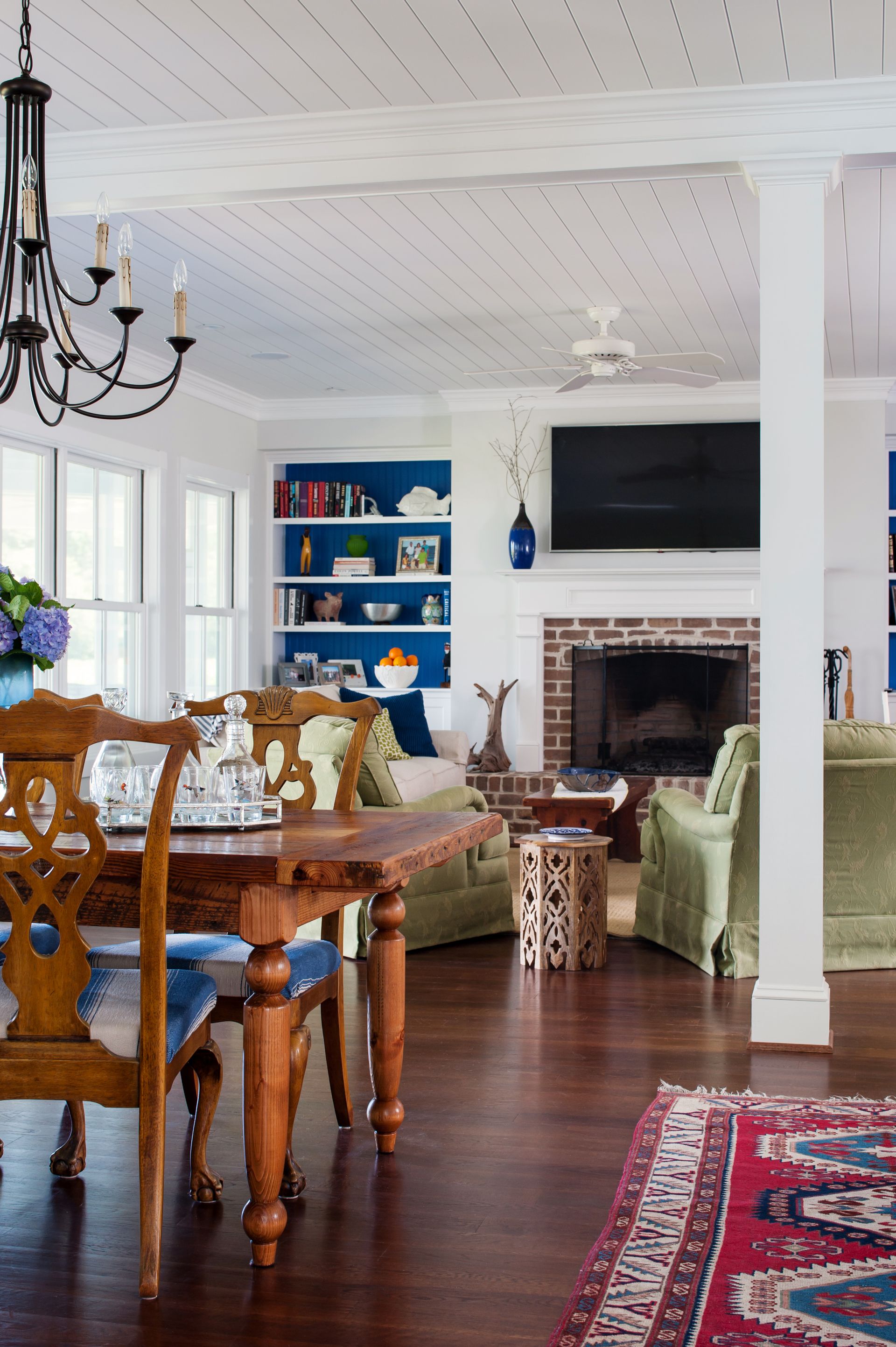 a house with a dining table and a fireplace in the background