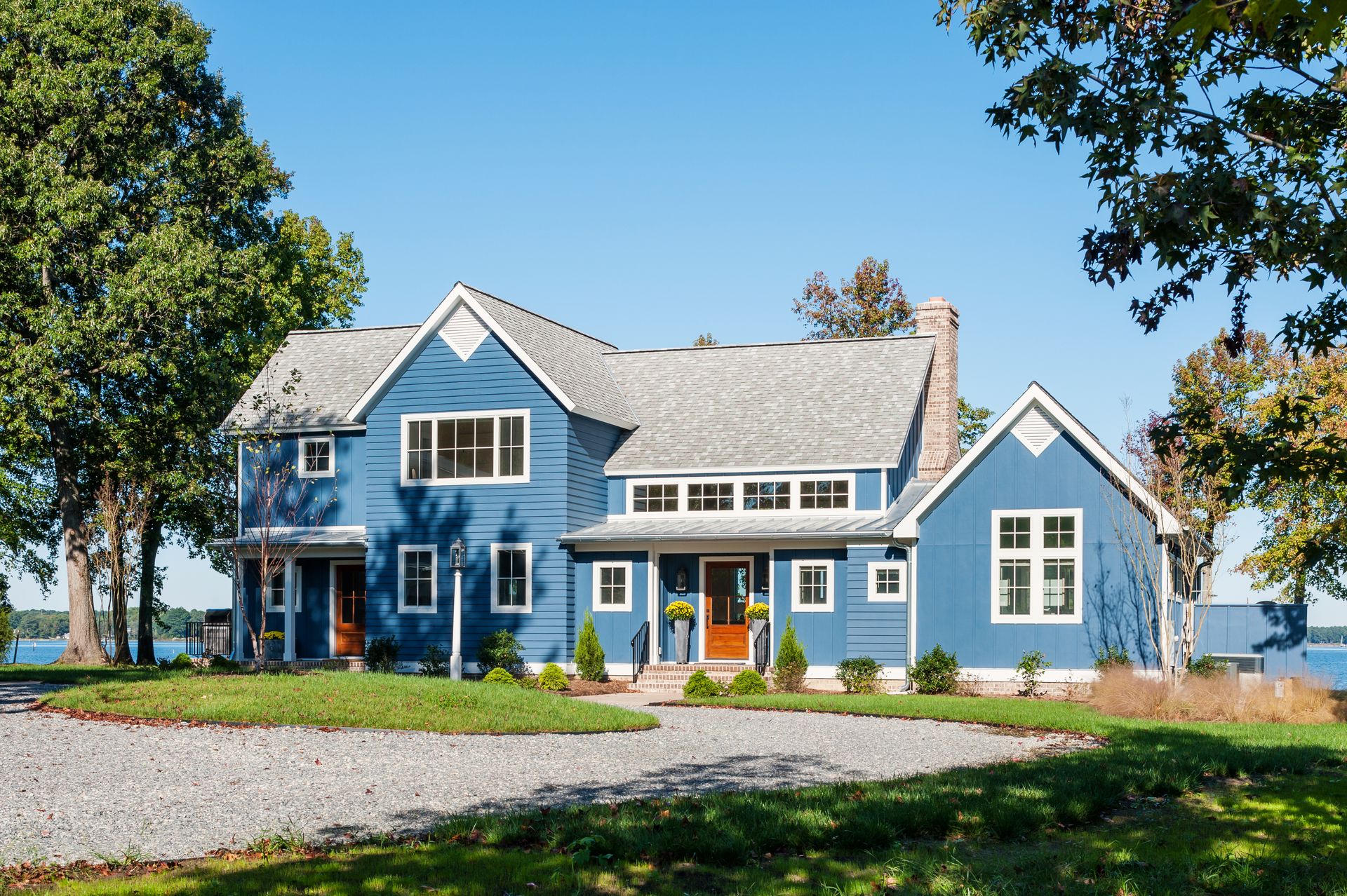 a blue house with white trim and a gray roof