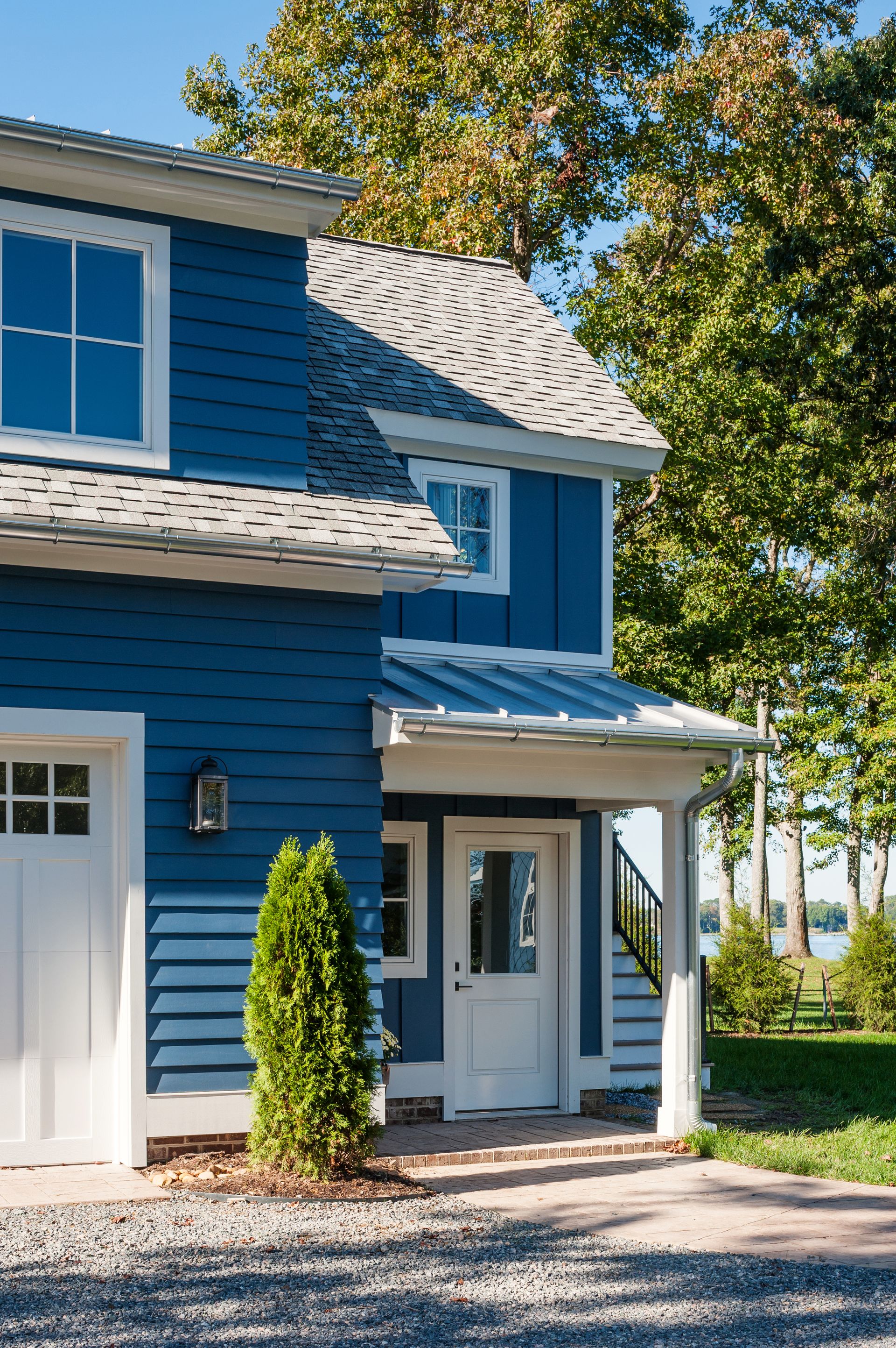 a blue house with white trim and a white door