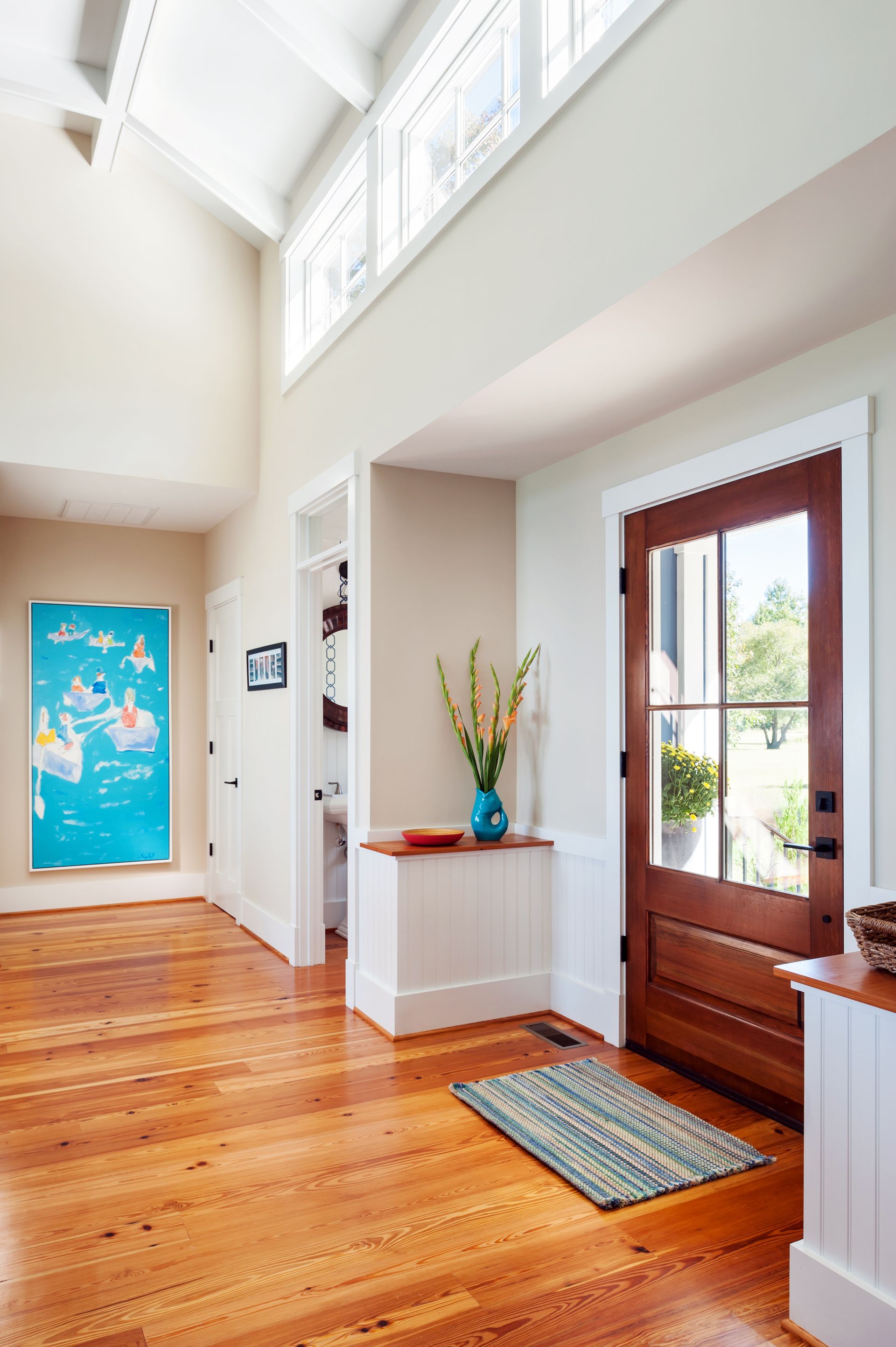 a hallway with hardwood floors and a sign that says