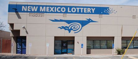 A new mexico lottery building with a blue logo on the side