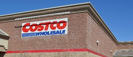 A costco wholesale store with a blue sky in the background