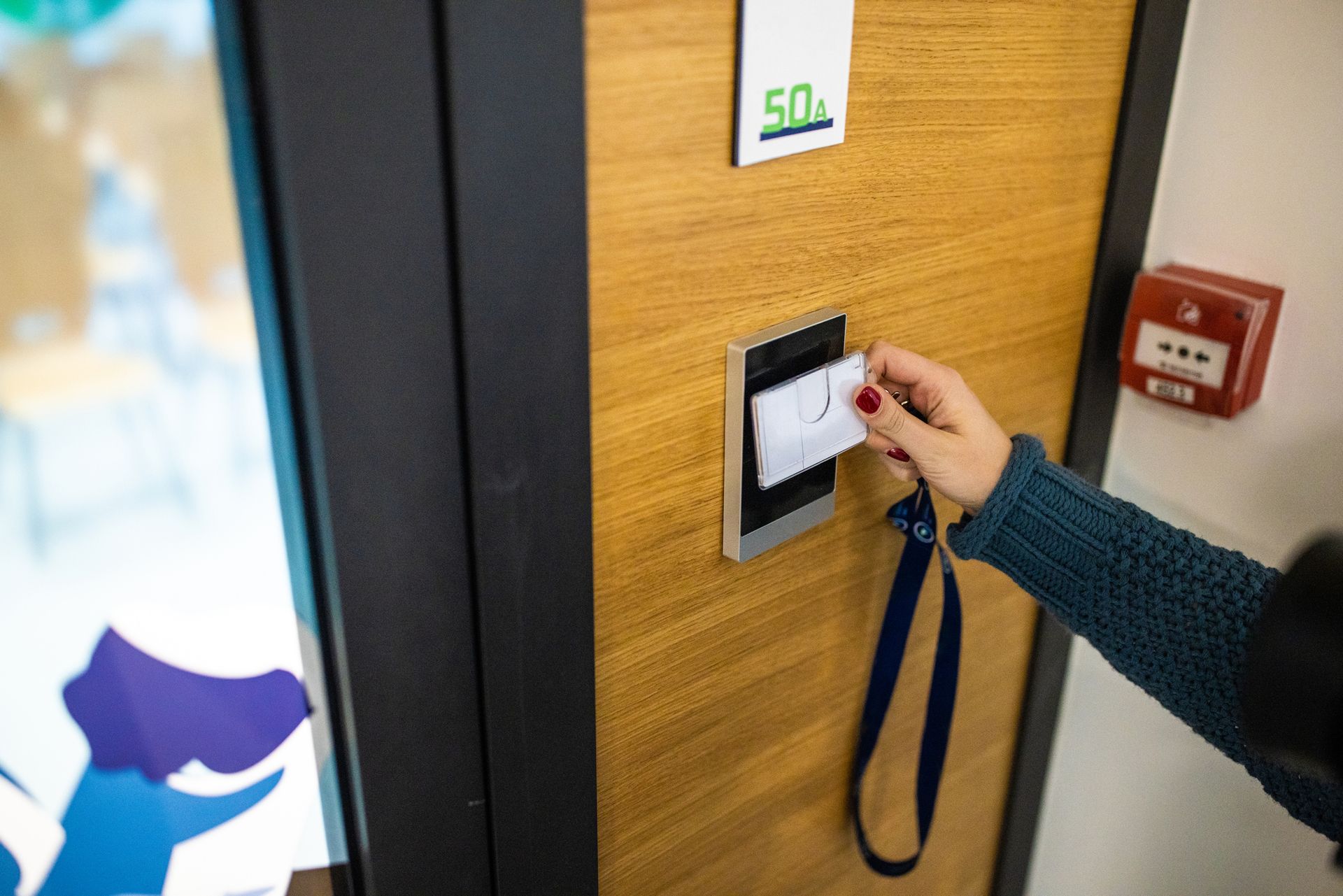 A person is using a key card to open a door.