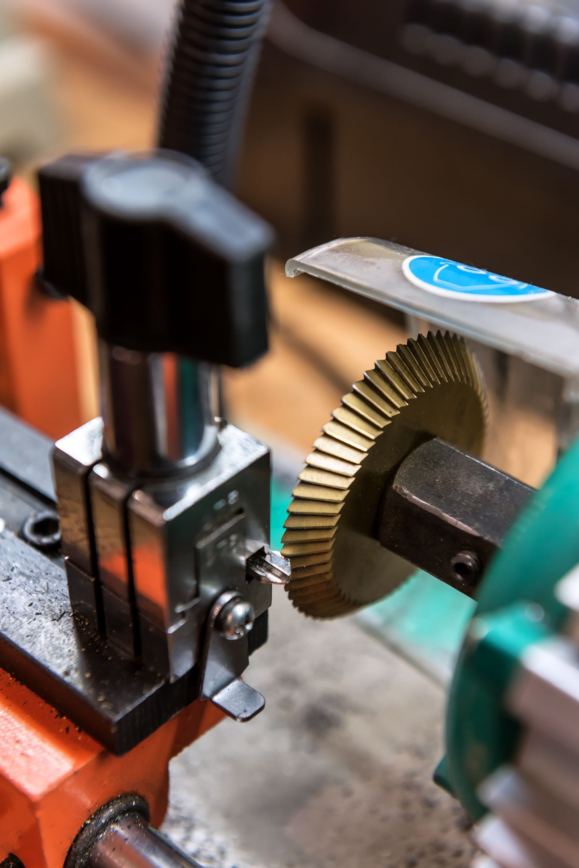 A close up of a machine cutting a key on a table.