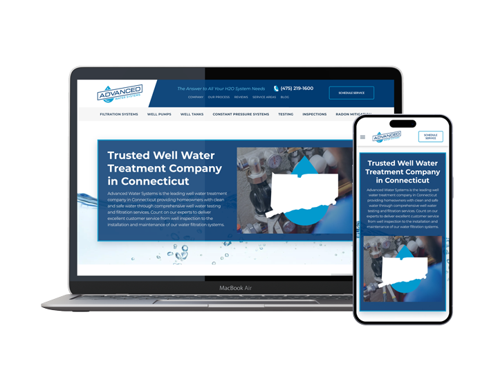 A laptop and a cell phone are sitting next to each other on a white background.