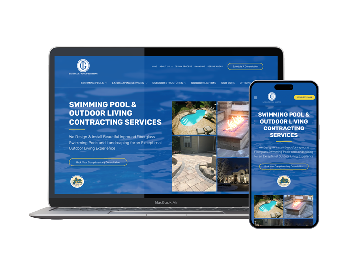 A laptop and a cell phone are sitting next to each other on a white background.