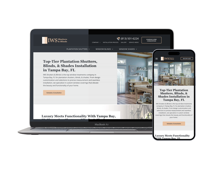 A laptop and a cell phone are sitting next to each other on a white background.