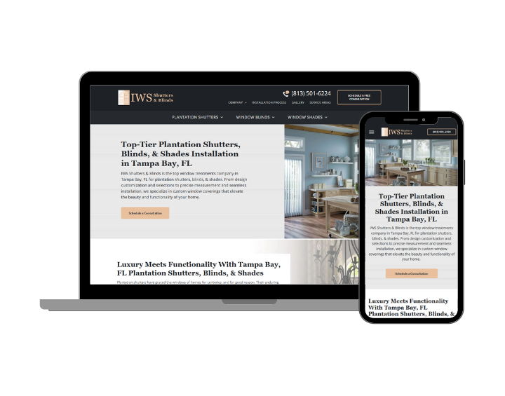 A laptop and a cell phone are sitting next to each other on a white background.