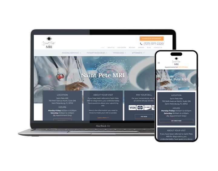 A laptop and a cell phone are sitting next to each other on a white background.