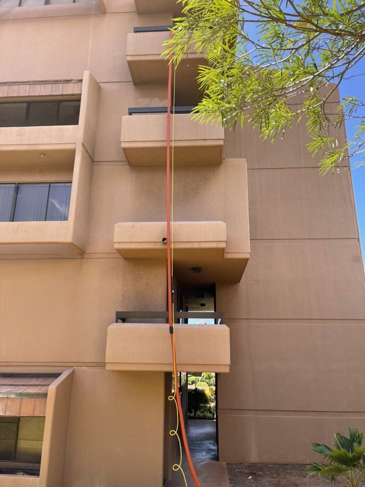 A large building with a hose attached to the side of it.