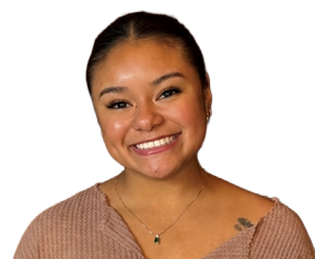 A woman wearing a black sweater and a lace top smiles for the camera.