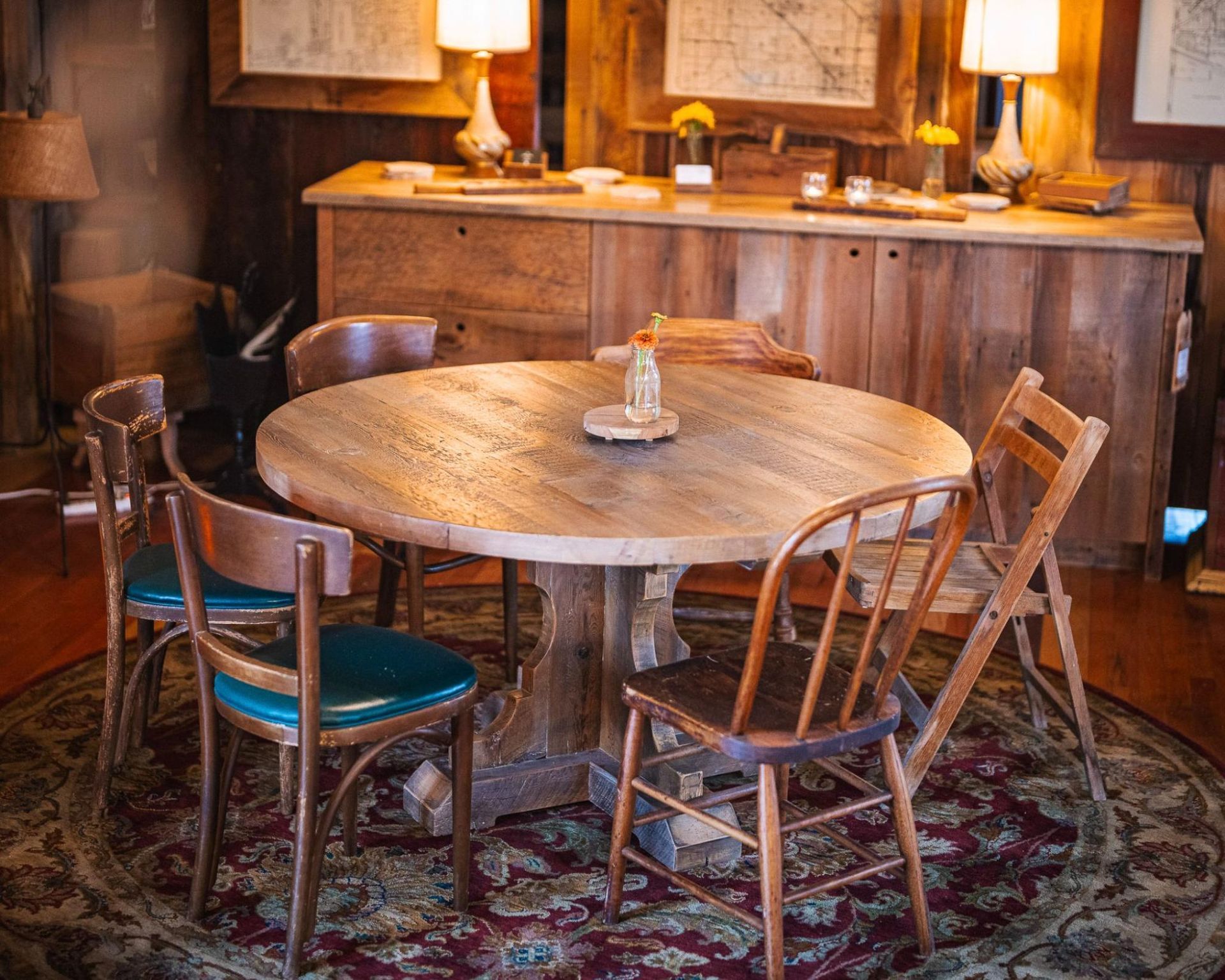 A dining room with a reclaimed wood table and chairs