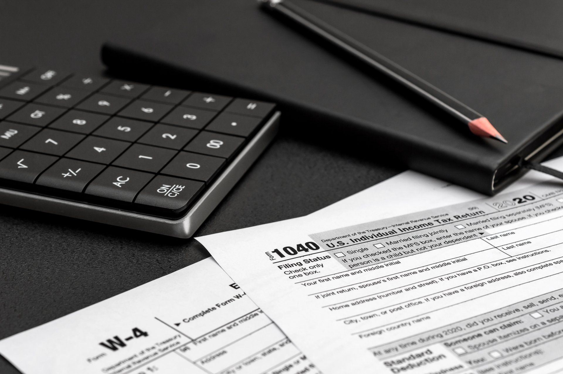 A calculator is sitting on top of a 1040 form