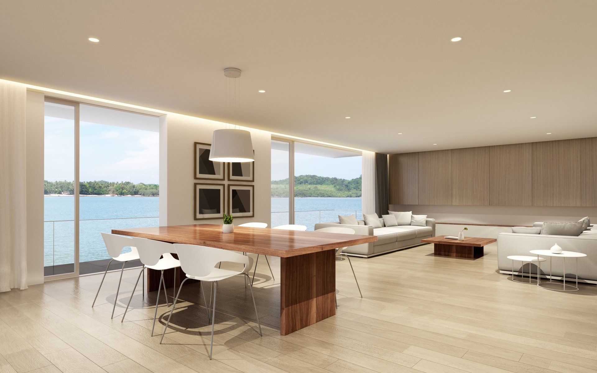Salon moderne avec table à manger, chaises, canapé et vue sur le front de mer.