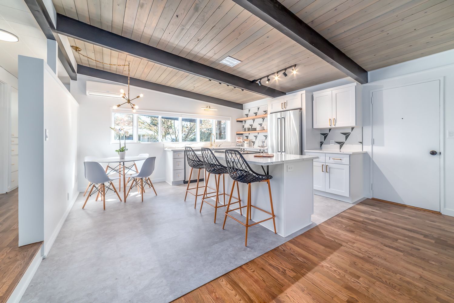 A man is measuring a wall with a tape measure.