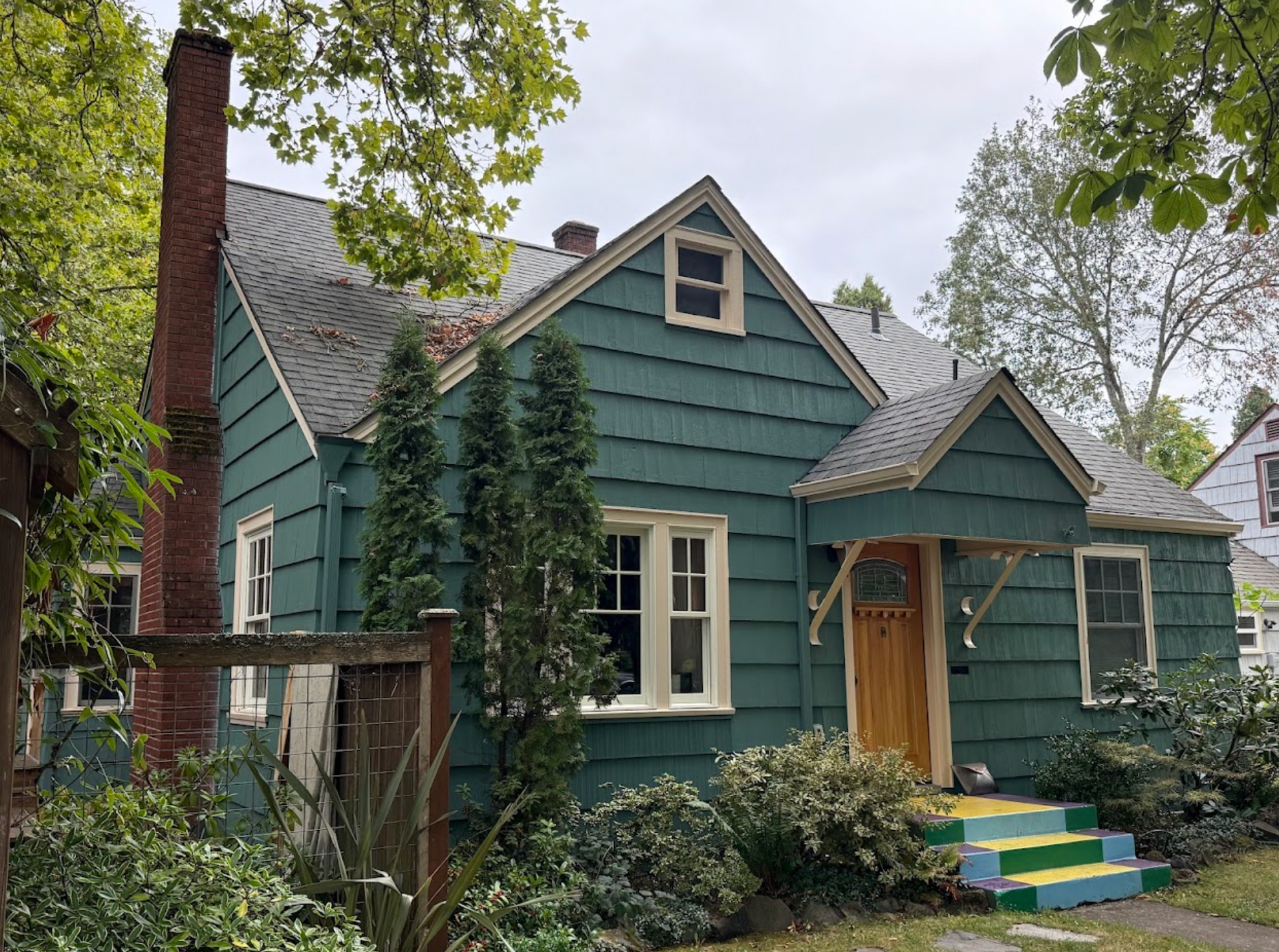 A man is painting a wall with a roller.
