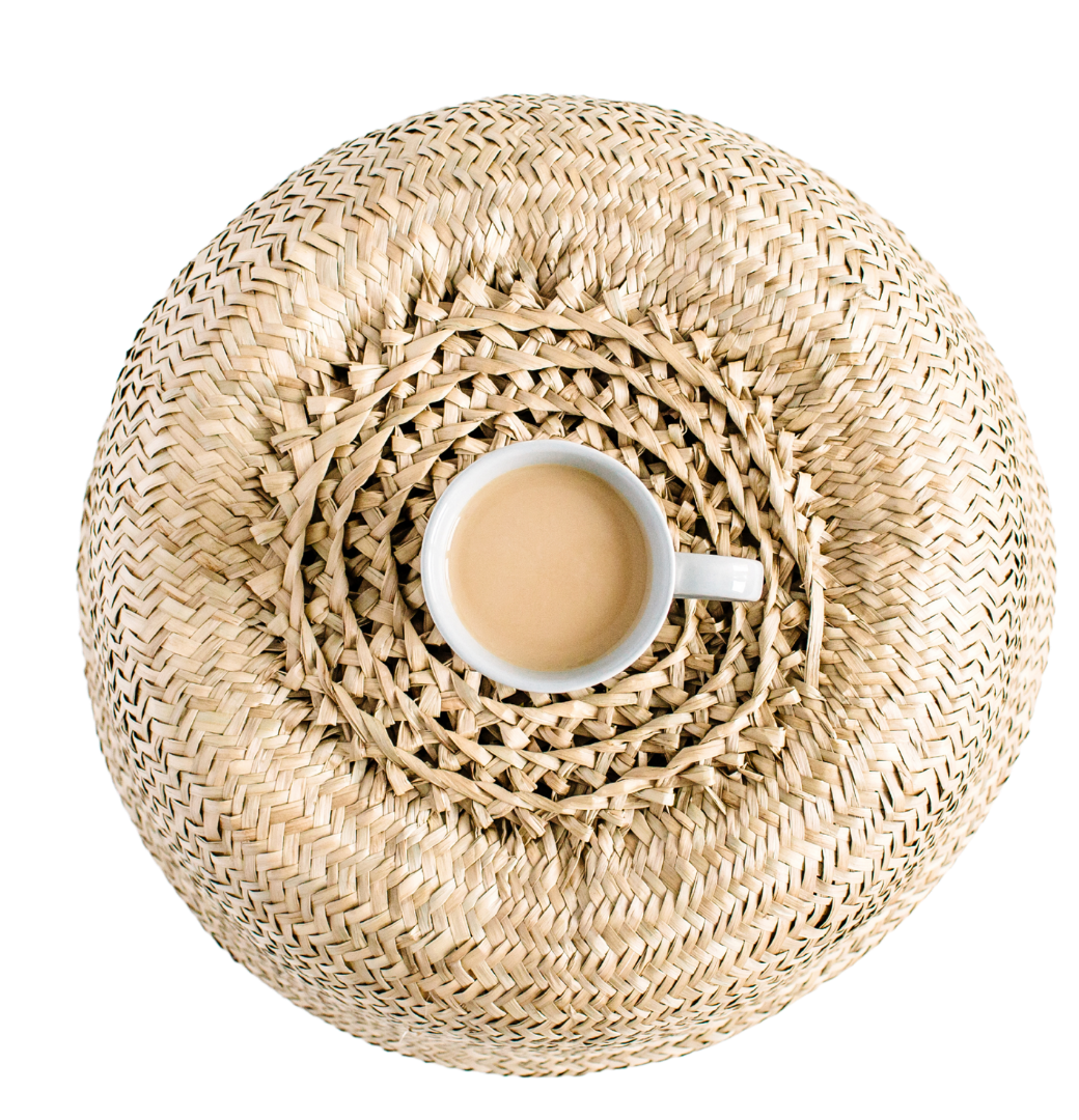 Cup of coffee on woven mat.