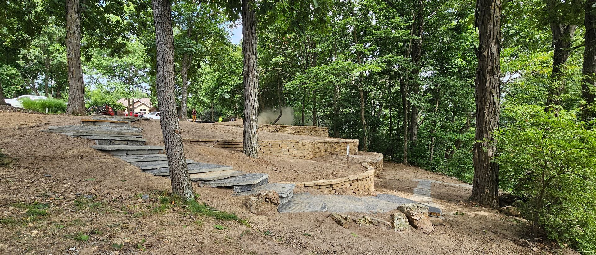 A brick house with a newly landscaped front yard, featuring mulch, rocks, and plants.