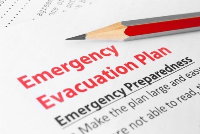 A pencil rests on top of an emergency evacuation plan