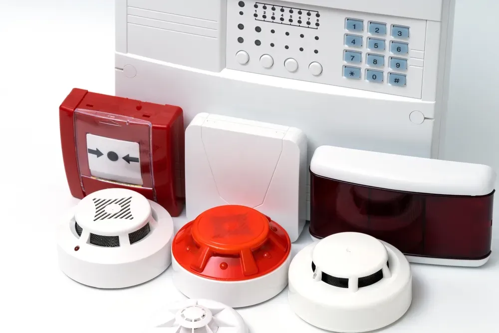 Fire safety equipment: alarm control panel, pull station, smoke detectors, and sounders.