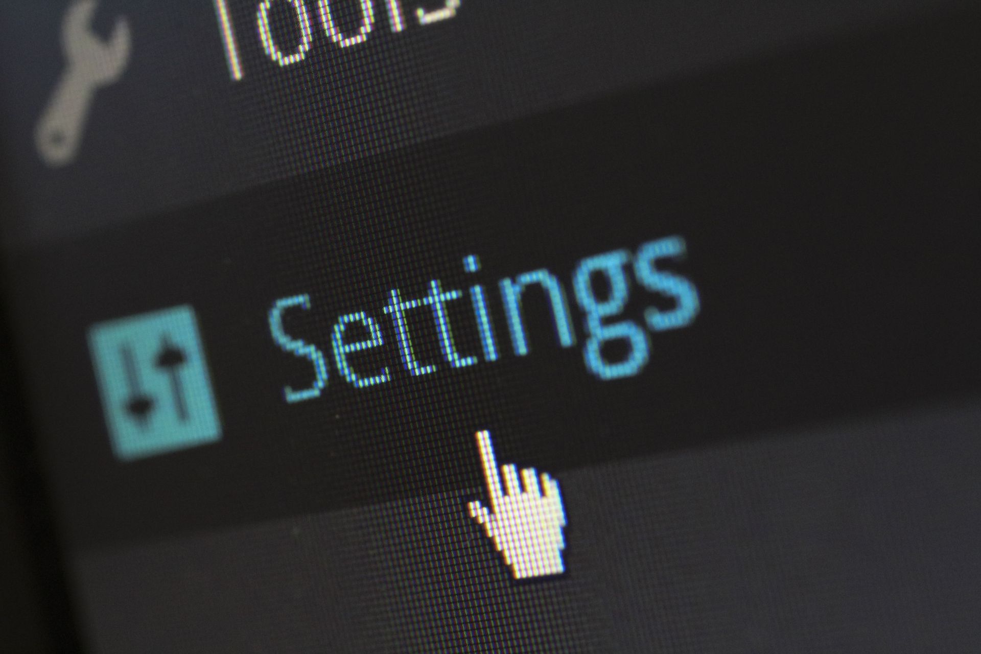 Mouse cursor hovering over a blue “Settings” option on a dark interface.